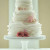 The wedding cake can also be decorated by flowers in strawberry colors. It doesn't have to be strawberries.