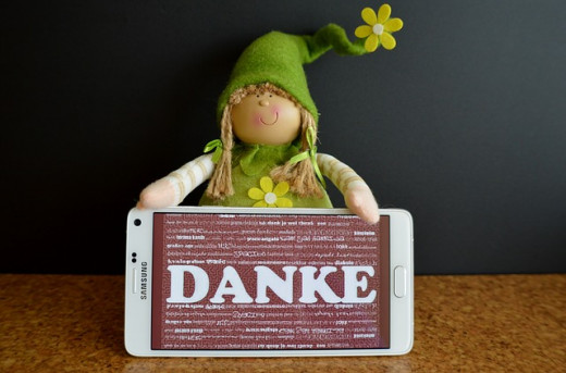 thank you with a danke and a little blond doll in a green cap