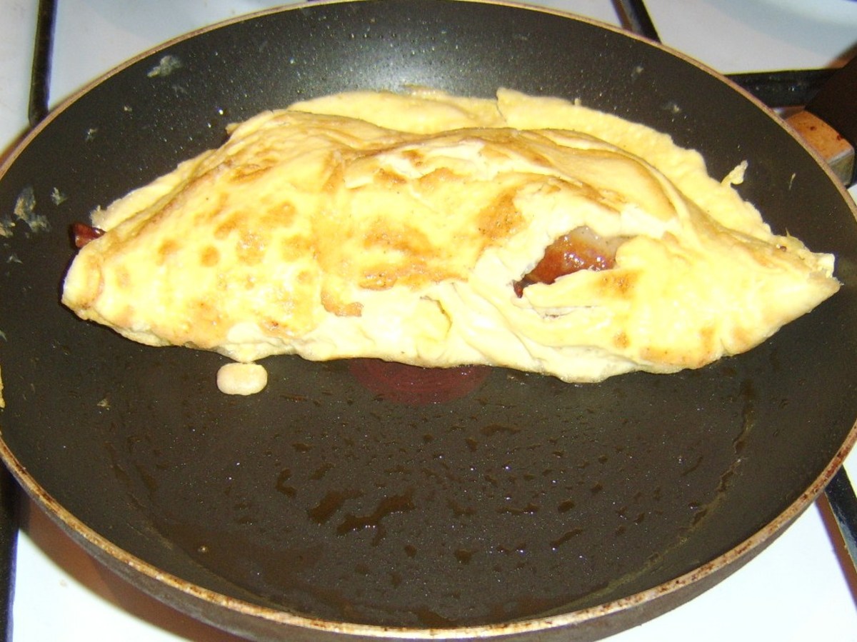 Duck egg omelette is folded over sausages and bacon
