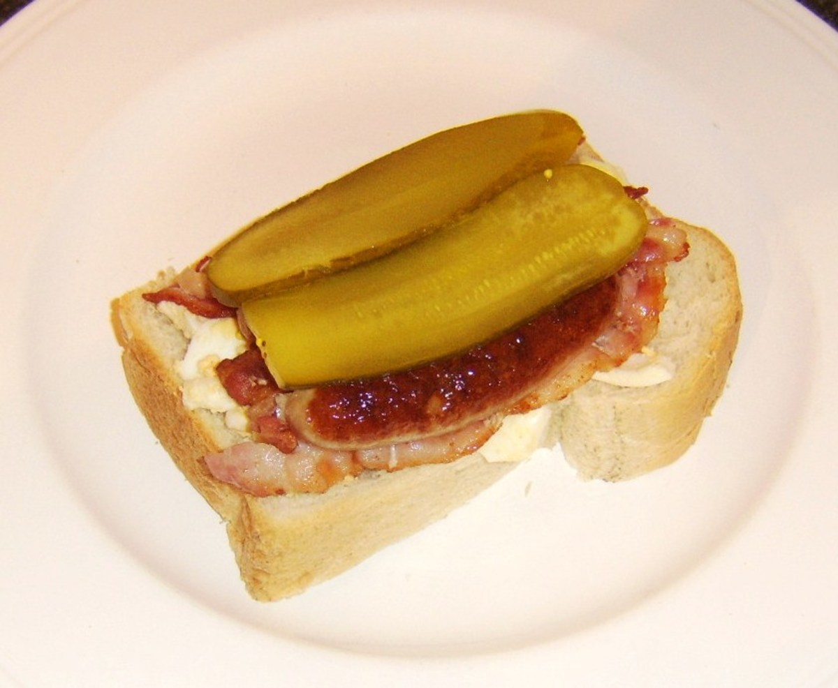 Pickles are the final sandwich additions before it is topped with a second slice of bread