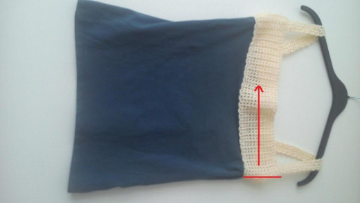 When you crochet the back, you will begin at one side seam and work your way back and forth across the back to the other side seam