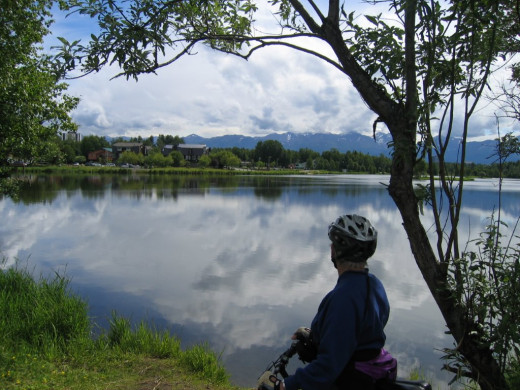 Jeanne overlooking Mt. McKinley in Alaska on her bike