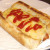 Crispy topped mac and cheese dog with ketchup Crispy topped mac and cheese dog with ketchup