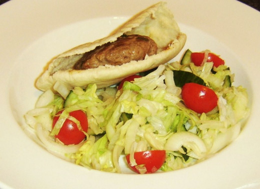 Lamb burger in pitta bread laid on salad bed