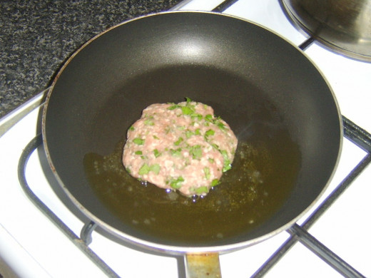 Frying lamb burger in olive oil