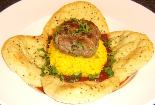 Succulent lamb burger on turmeric rice with bhuna sauce and naan bread