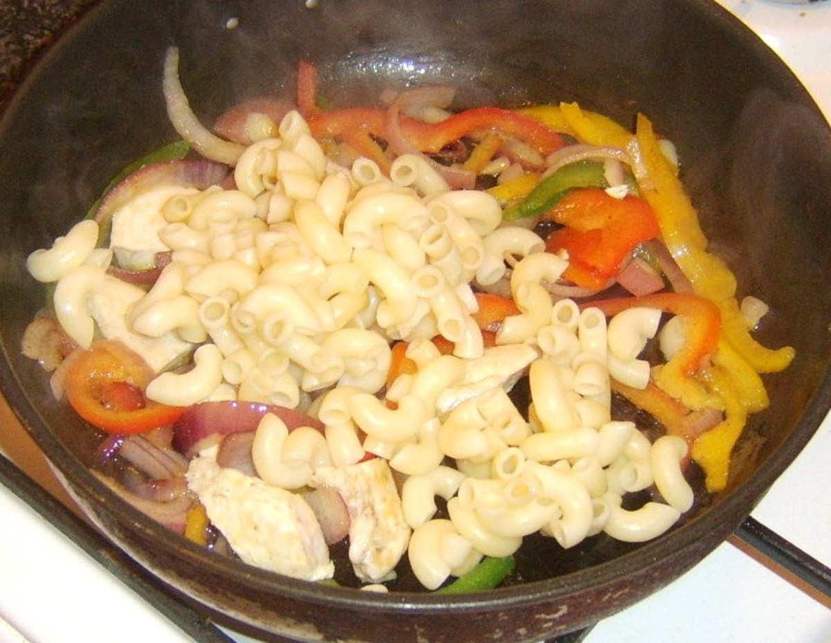 Cooked and drained macaroni is added to chicken and bell peppers