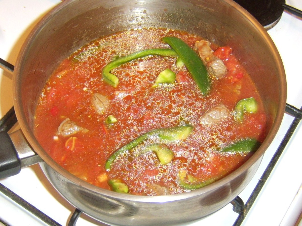 Beef and tomato stew is brought to a simmer