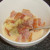 Bacon and tortelloni are added to beaten eggs