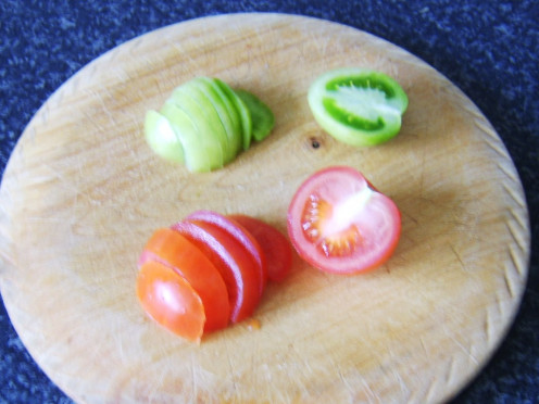 The tomatoes are halved and then sliced