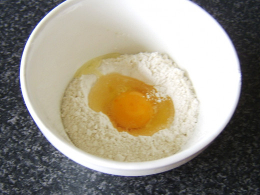 Egg is added to a well in the centre of the flour