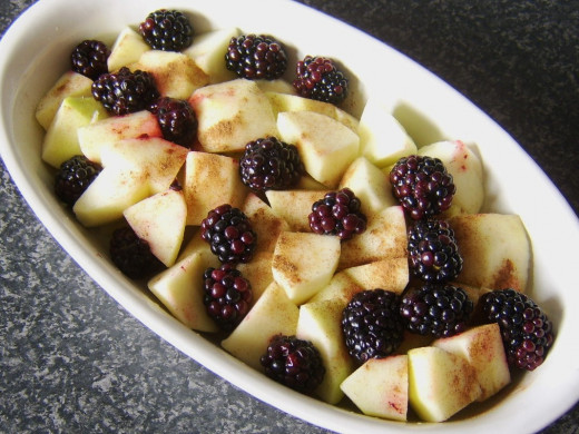Blackberries are placed evenly on top of apples