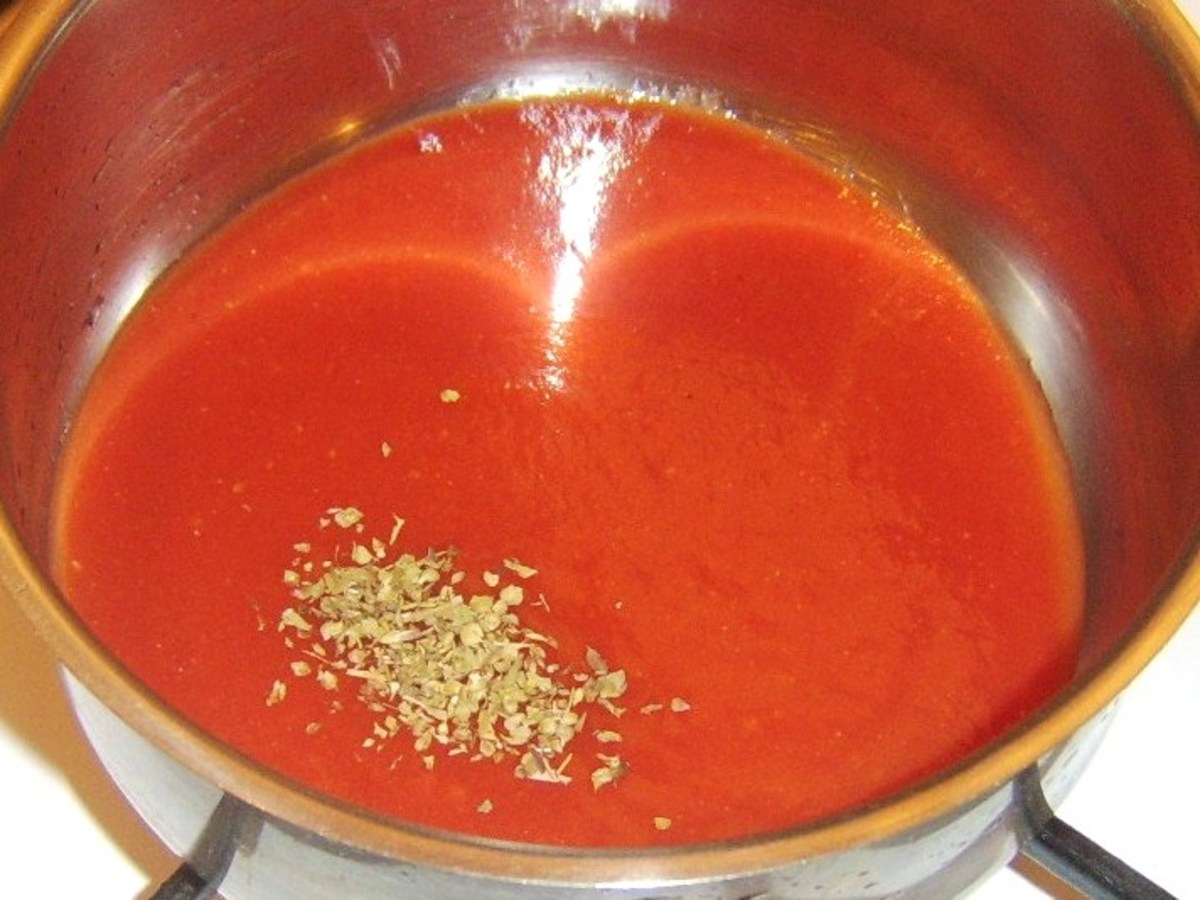 Oregano is added to tomato sauce