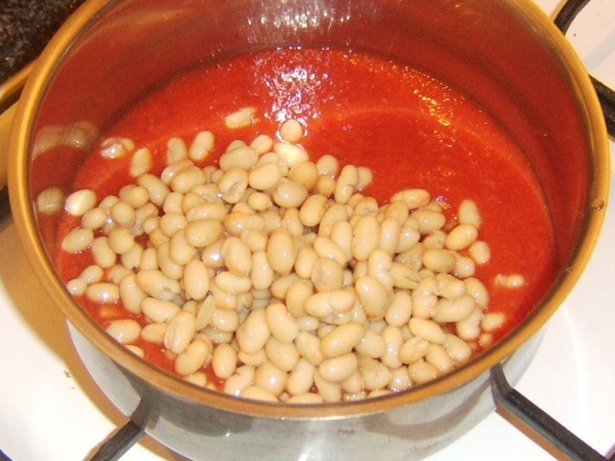 Haricot beans added to spicy tomato sauce