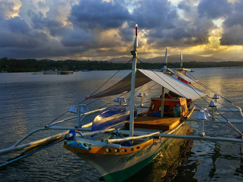 Solar lit banca at sunset at sunset at Mangingisda pier, Puerto Princesa, Palawan.