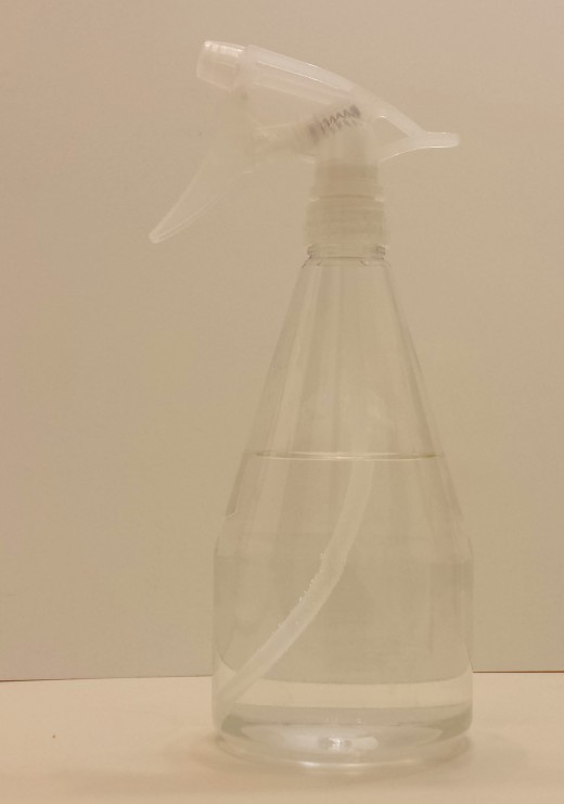 A spray bottle filled with diluted orange peel cleaning solution