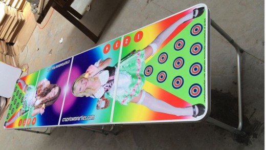 A beer pong table with the image of a German woman printed on