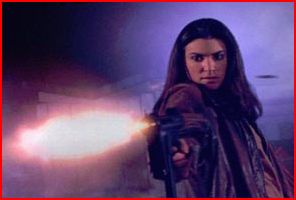 Charlie Roadtrap (Tara Bilkins) opens fire.