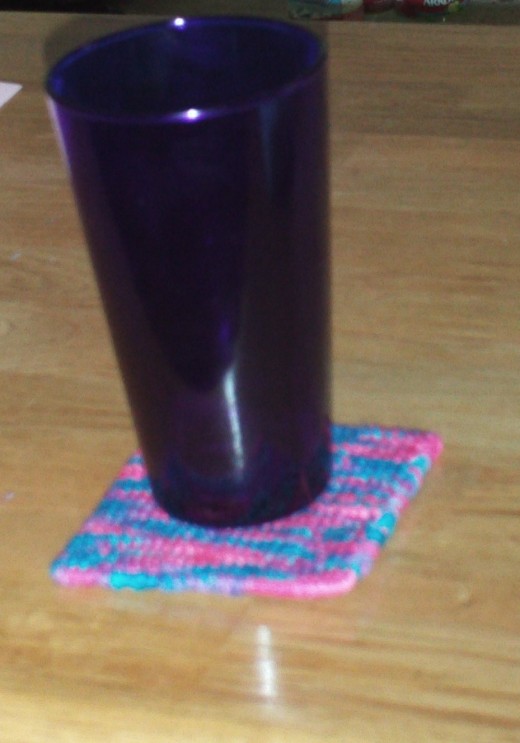 Coasters are like colorful little rugs you can place under your cups.  Thinks of coasters as dog beds for your glasses, and soon all of your drinking vessels will be wanting one.