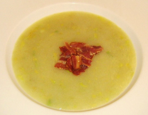 Celery and fennel soup is garnished with a little bit of crispy bacon