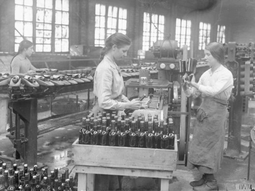Women labeling lager bottles in Cheshire, England