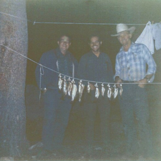 My dad on the left, proud of his catch.