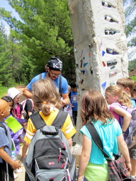 Students and members of the community came out to help artist Ben Zoltak work on his bird habitat sculpture