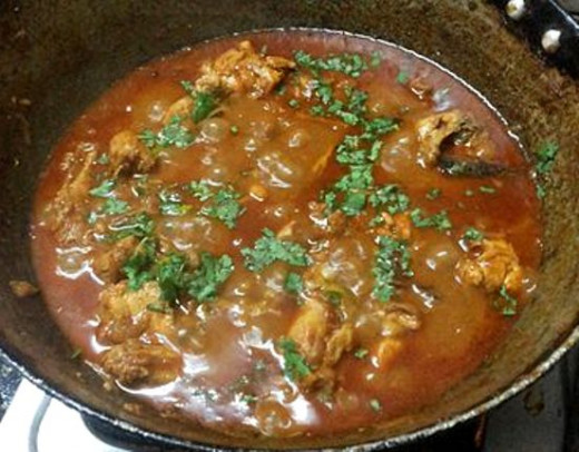 Chicken curry garnished with coriander leaves