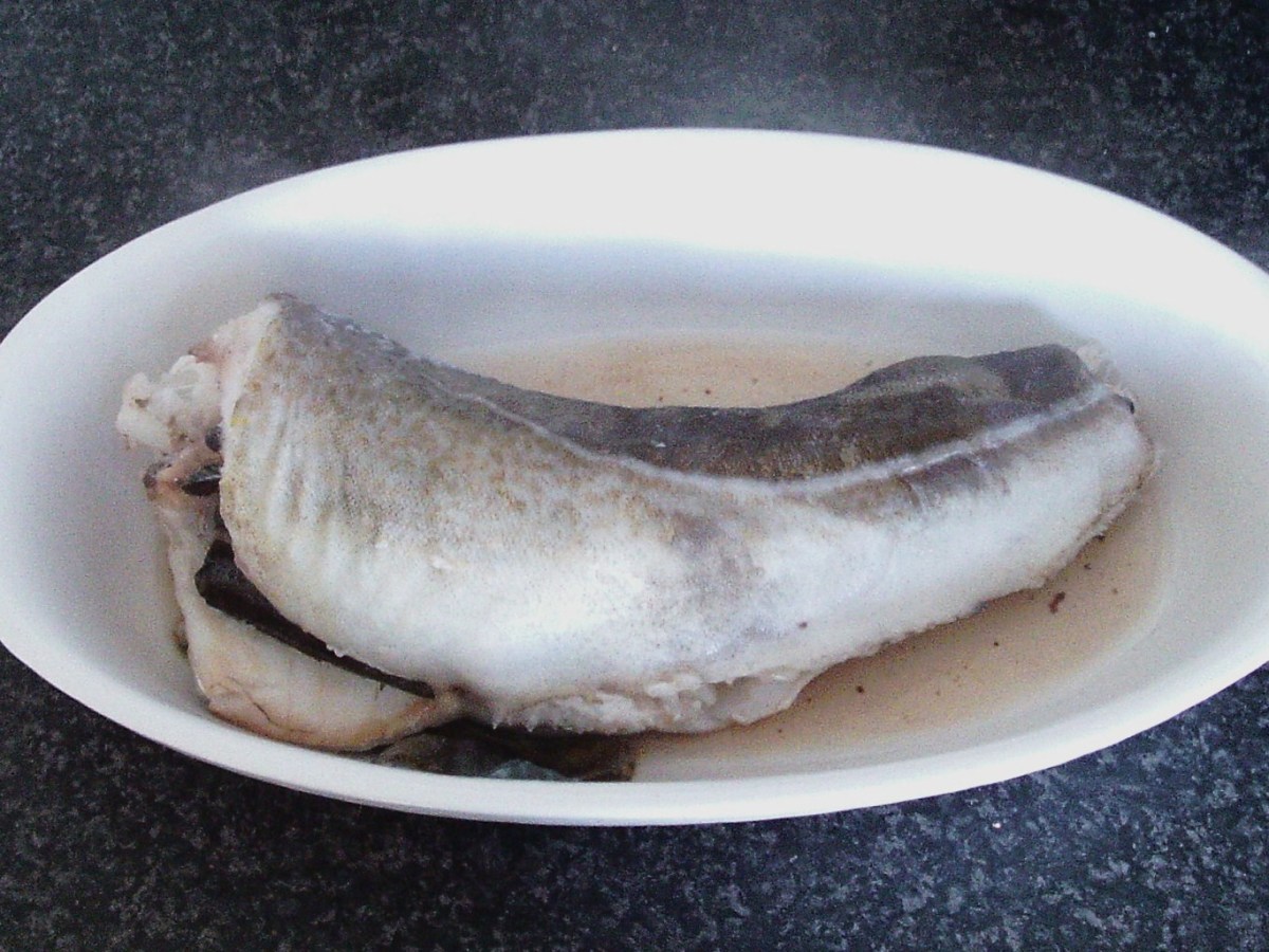 Poached codling is removed from pot
