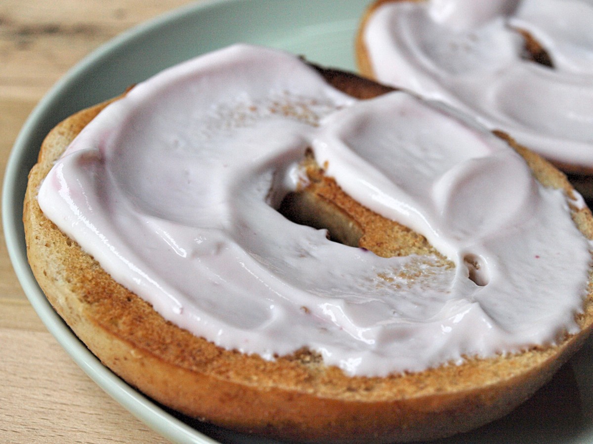 A smear of flavored yogurt on a wheat bagel makes a healthy snack or way to start the day.