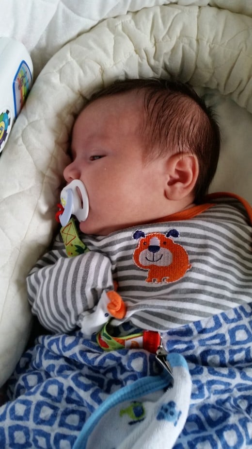 My son with his pacifier and clip.