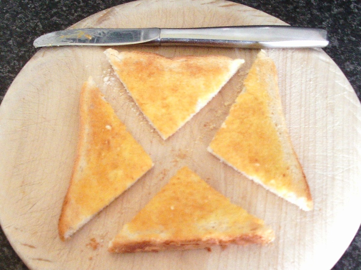 Toast slice is quartered on chopping board