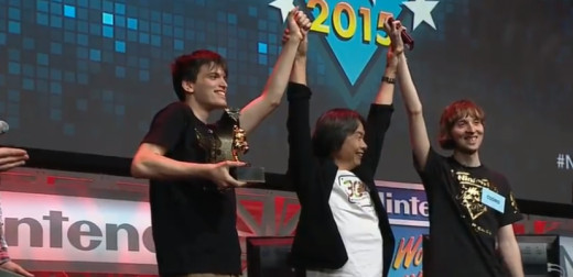 Shigeru Miyamoto near the winner John Numbers holding the gold mario statue and the runner up winner Cosmo. 