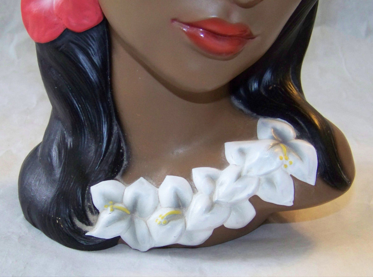 Beautiful details lei around her neck. She has the red and gold Lego foil label on felt bottom & marked with the Lego 3762/H marking. She is nine inches tall.