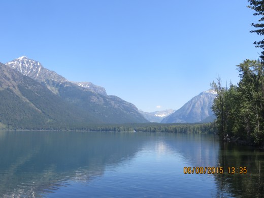 LOOKING NORTH ON LAKE McDONALD TOWARD MT. VAUGHT ON FAR LEFT, THEN MCPARKLAND, MT., THE GARDEN WALL IN THE CENTER, AND MT. CANNON ON RIGHT