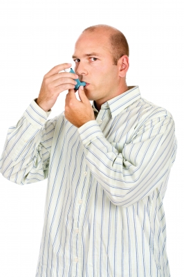 A Man Using Asthma Inhaler