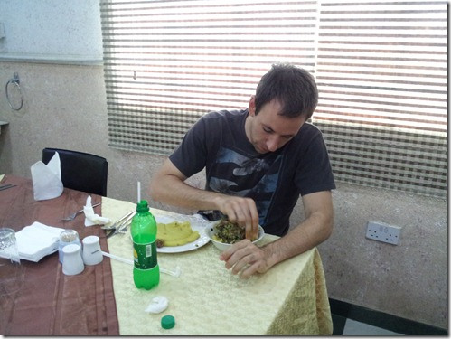 A foreigner enjoying Egusi soup with Eba 