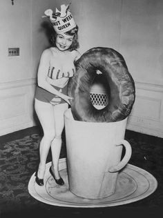 Retro beauty doing an ad for doughnuts and coffee.