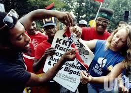 Demonstrators protesting a Ku Klux Klan march in Washington burn a Confederate flag prior to the event 9/2/1990. 