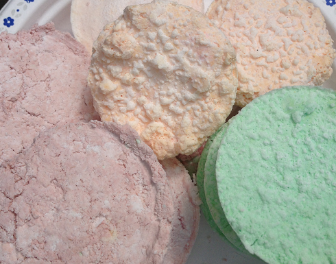Floral scented, orange scented, and mint scented bath bombs created in a muffin pan without a lid.