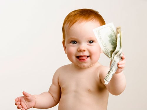 A baby holding money