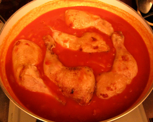Return the chicken legs to the pan.