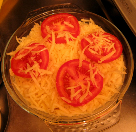 Topped with cheese and tomato in a 1.5 liter (three pint) ovenproof dish.