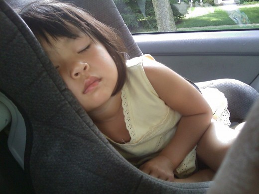 Sleeping child cozy inside a car