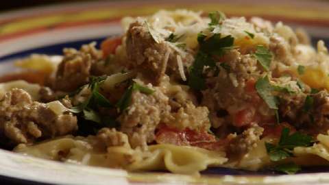Italian Sausage Primavera, served over bowtie pasta, garnished with parsley and fresh grated romano cheese.