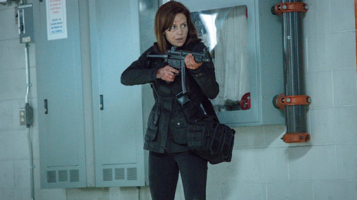 Kate Hewson armed with a gun