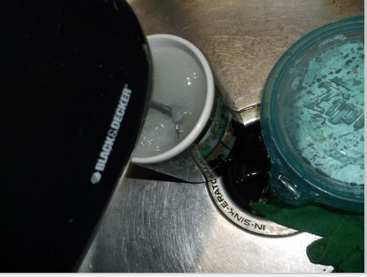 clean blades with mixer blades in cup of warm water