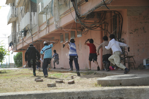 Israeli children running for shelter as an air siren sounds. Israeli children running for shelter as an air siren sounds.