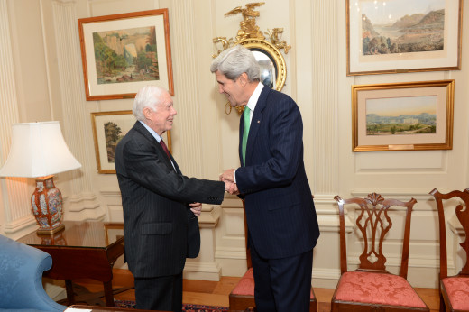 President Jimmy Carter shakes hands with Secretary John Kerry.