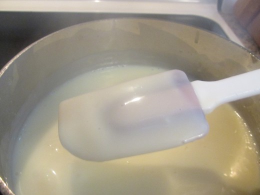 The cream starts to get thick when it starts clinging to the spatula.